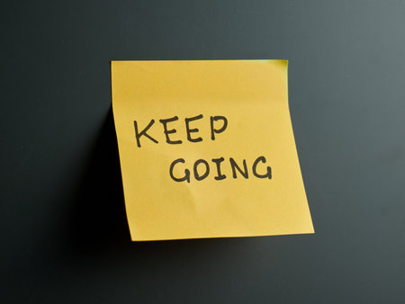 Bright yellow note encourages persistence and determinationの写真素材