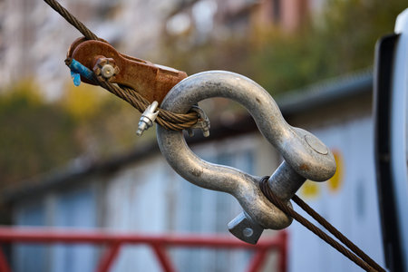Close view of a metallic hook and pulley on a cable.の写真素材