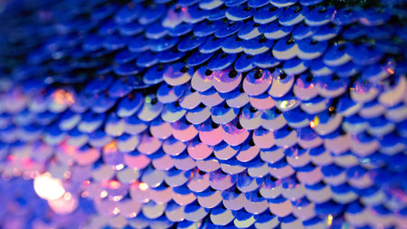 Close-up view of shiny blue sequins reflecting lightの写真素材