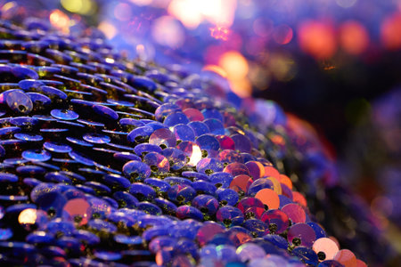 Shiny sequins reflect bright colors on fabric.の写真素材