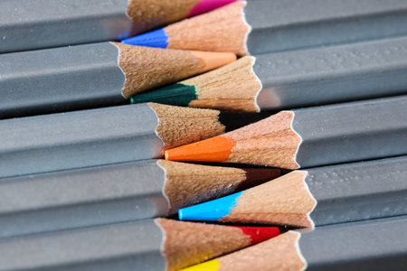 Colorful pencils rest on gray surfaces.の写真素材
