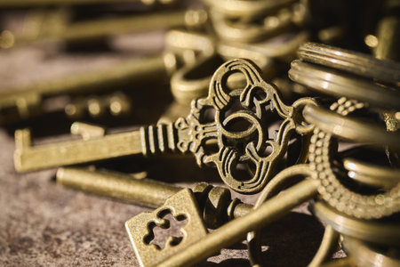 A collection of antique keys displayed on a dark surface.の写真素材