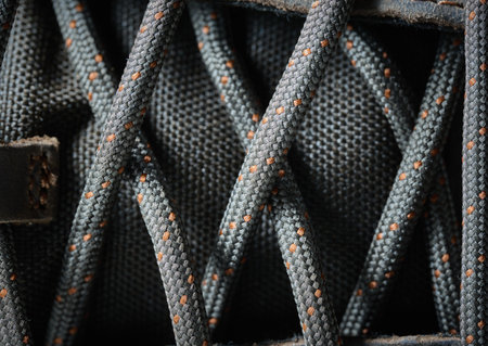 The shoelaces are tightly laced on a brown shoe surfaceの写真素材