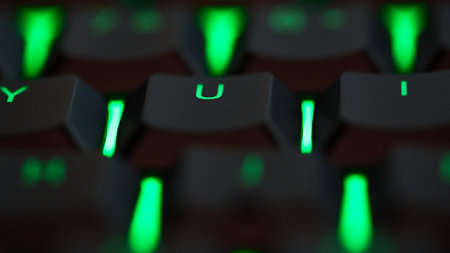 Macro shot of a gaming keyboard with colorful RGB LED backlighting across the mechanical switches. High quality photoの写真素材