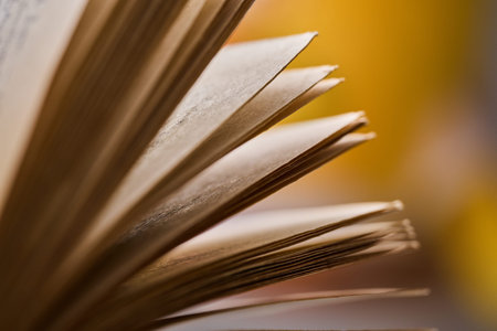 Detailed view of aged paper layers and book binding with soft focus and warm lighting