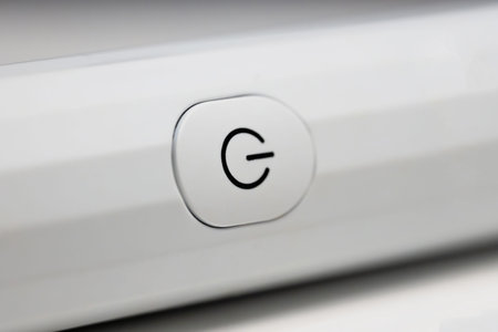 Close view of a power button on a device in a bright room setting.