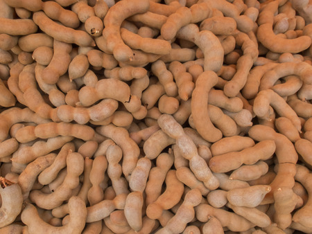 Pile of Sweet tamarind on wood plank Background Textureの写真素材