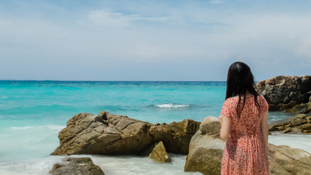 Back of Wet Asian Lady Looking at Clear Sea and Sky for Copyspace used as Templateの写真素材