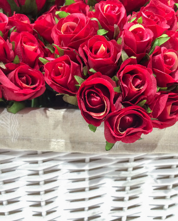 Artificial Red Roses in The White Basket Background Texture, Vintage Themeの写真素材