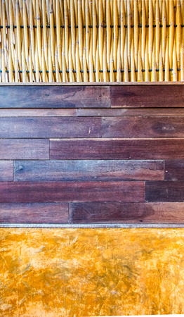 Abstract Wall Created with Weaving Bamboo Piece, Brown Wood Panel and Orange Clayの写真素材
