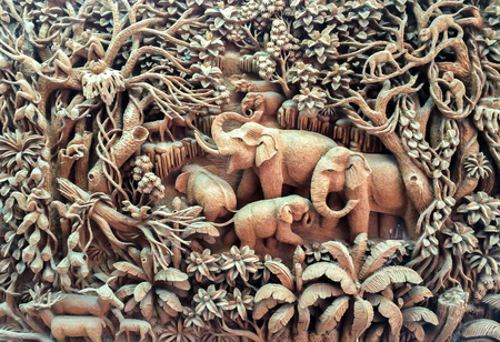 Carved Elephant Family in The Wood on The Wooden Frameの写真素材