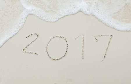 Happy Upcoming New Year 2017 Start with Fresh Concept, Numbers 2017 Handwritten on White Sea Sand...