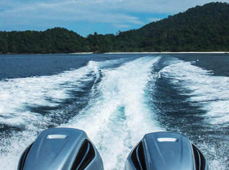 Speedy Sea Boat Prop Wash, White Wake on The Blue Ocean from Big Two Motor with Island of Thailand in Background used as Template to mock up or input Textの写真素材