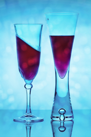 Two wine glasses with different levels of liquid - glass half full conceptの写真素材