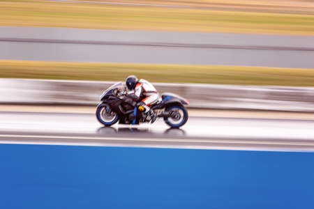 A racing motorcycle competitor at a drag way meet to keep speed off the streetsの写真素材