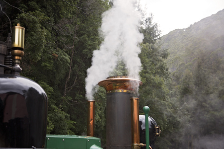 The funnel of an historic steam train puffing smokeの写真素材