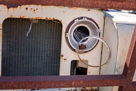 Close up of the front of an old abandoned and rusted carの写真素材