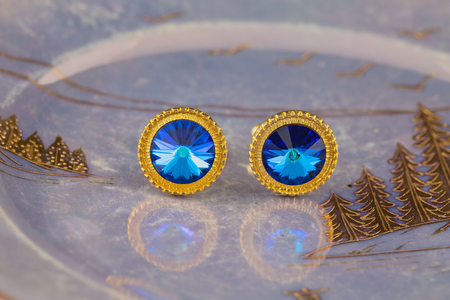 Vintage large gold blue stone cuff links on a lustrous plateの写真素材