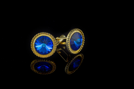 Vintage large gold blue stone cuff links on black backgroundの写真素材