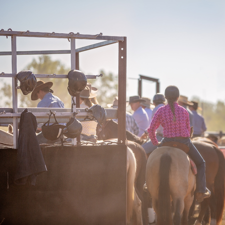 Cowboys waiting in holding area to take their turn in camp drafting competition at a country rodeoの写真素材