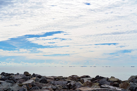Foreign ship tankers waiting to load coal from a port in Australia under an amazing cloudy sky