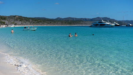 WHITSUNDAYS, AUSTRALIA - AUGUST 24TH: Tourists enjoying the clear blue water and white silicon sand of Whitehaven Beach in the Whitsunday Passage, Queensland on 24th August 2018. Tourists swim all year round, even in the winter months.のeditorial素材