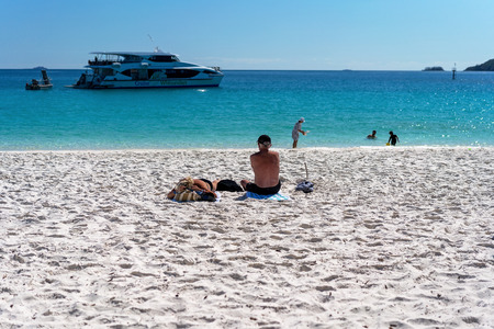 WHITSUNDAYS, AUSTRALIA - AUGUST 24TH: Tourists enjoying the clear blue water and white silicon sand of Whitehaven Beach in the Whitsunday Passage, Queensland on 24th August 2018. Tourists swim all year round, even in the winter months.のeditorial素材