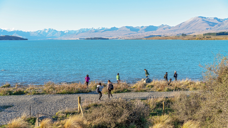 LAKE TEKAPO, NEW ZEALAND - April 2018: The beauty of the majestic alps on the glacial shores of Lake Tekapo attract tourists in their thousands each each. 16th April 2018.のeditorial素材