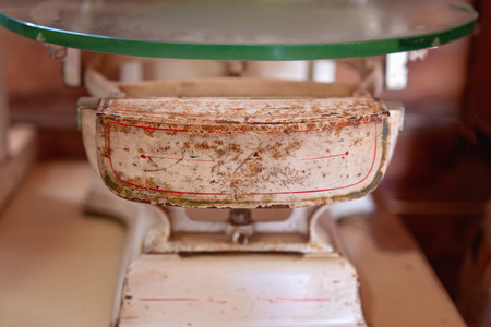 Close up of old vintage scales with a glass top for weighing in the olden daysの写真素材