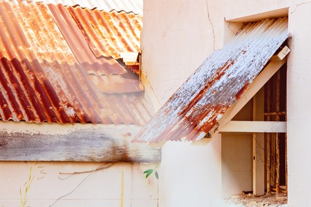 Red corrugated iron roof and window awning over an old Australian homesteadの写真素材