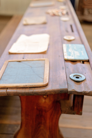 Vintage wooden student form desk with inkwell and slate as used in a school room in yesteryearの写真素材