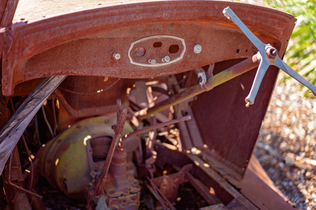 Close up of part of a rusted old vintage car wreck falling apart and left abandonedの写真素材
