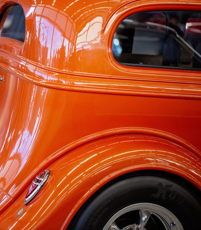 MACKAY, QUEENSLAND, AUSTRALIA - 13th July 2019: Close up of side and back of orange custom classic...