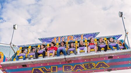 SARINA, QUEENSLAND, AUSTRALIA - AUGUST 2019: People enjoying a high and fast thrill ride at Sarina local country showのeditorial素材