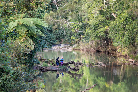 Mackay, Australia - August 25th 2019: Male and female photographers standing on the banks of Broken...
