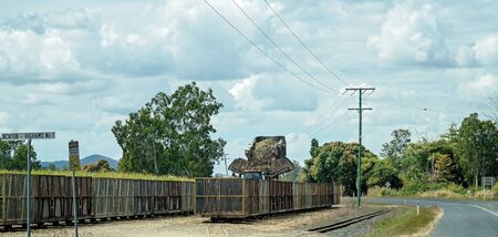 Mackay, Australia - August 25th 2019: Farmer emptying his harvested sugar cane into bins for transportation by rail to the refineryのeditorial素材