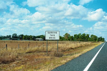 Survive this drive roadside sign on an Australian country highwayの写真素材