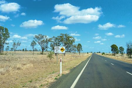 A sign warning of stock droving on an Australian inland highwayの写真素材