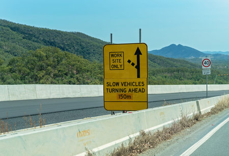 Sarina, Queensland, Australia - October 2019: Warning of slow vehicles turning into a work site on a mountain range highwayのeditorial素材
