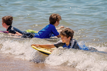 Mackay, Queensland, Australia - October 2019: Children enjoying an ocean swim on a summery day at...