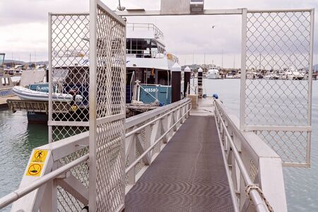 Yeppoon, Queensland, Australia - December 2019: Freedom Flyer catamaran moored at a marina ready to board tourists on an adventure cruiseのeditorial素材