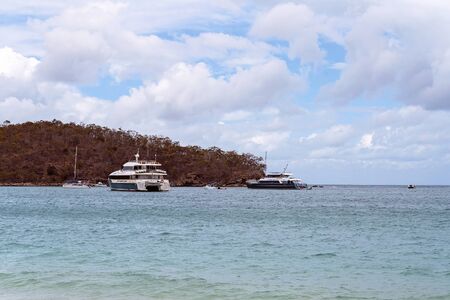 Yeppoon, Queensland, Australia - December 2019: Tourist boats moored offshore at Great Keppel Island on the Great Barrier Reef, ready to pick up passengersのeditorial素材