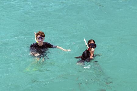 Yeppoon, Queensland, Australia - December 2019: A brother and sister caucasian children snorkeling in the waters over a shallow coral reef near Great Keppel Islandのeditorial素材