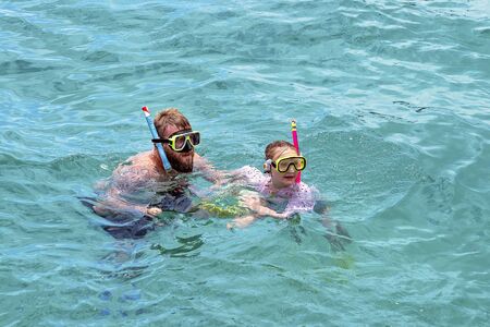 Yeppoon, Queensland, Australia - December 2019: Father and daughter snorkeling in the waters over a shallow coral reef near Great Keppel Island on the Great Barrier Reefのeditorial素材