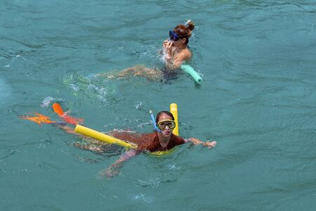 Yeppoon, Queensland, Australia - December 2019: A caucasian mother and daughter snorkeling in the waters over a shallow coral reef near Great Keppel Island on the Great Barrier Reefのeditorial素材