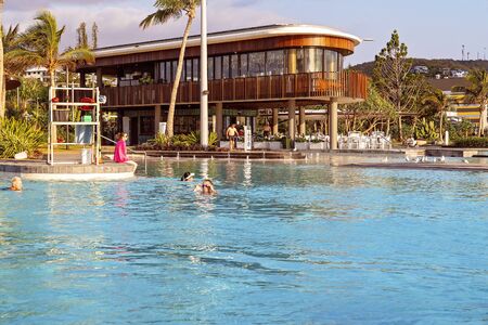 Yeppoon, Queensland, Australia - December 2019: Early morning swimmers at the lagoon with infinity edge pool on the beach, a public recreation areaのeditorial素材