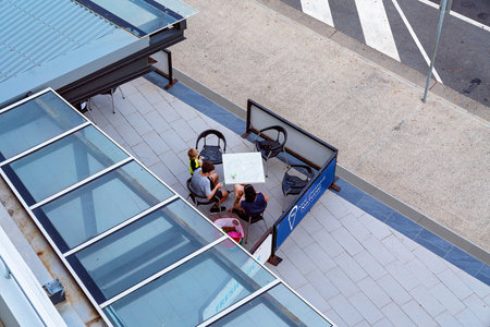 Yeppoon, Queensland, Australia - december 2019: A family enjoying dining outdoors enjoying icecream