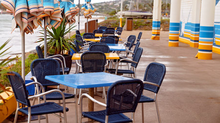 Capricorn Coast Australia - Tables and chairs set up for dining near the beach, all wet from a rain...