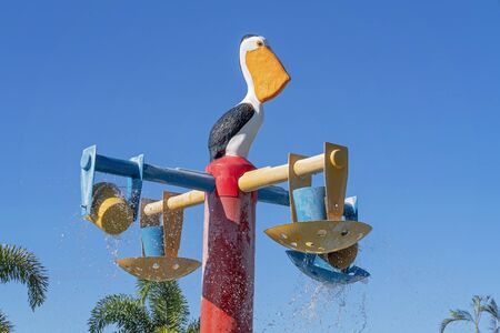 Mackay, Queensland, Australia - December 2019: A pelican statue water spray in water park at holiday villageのeditorial素材