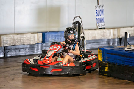 Mackay, Queensland, Australia - January 2020: A young girl drives a go-kart in a fun recreational...